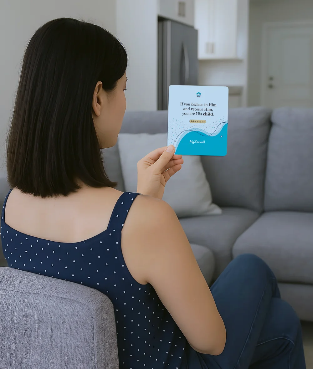 Identity in Christ Affirmations card being read by Asian woman in her living room