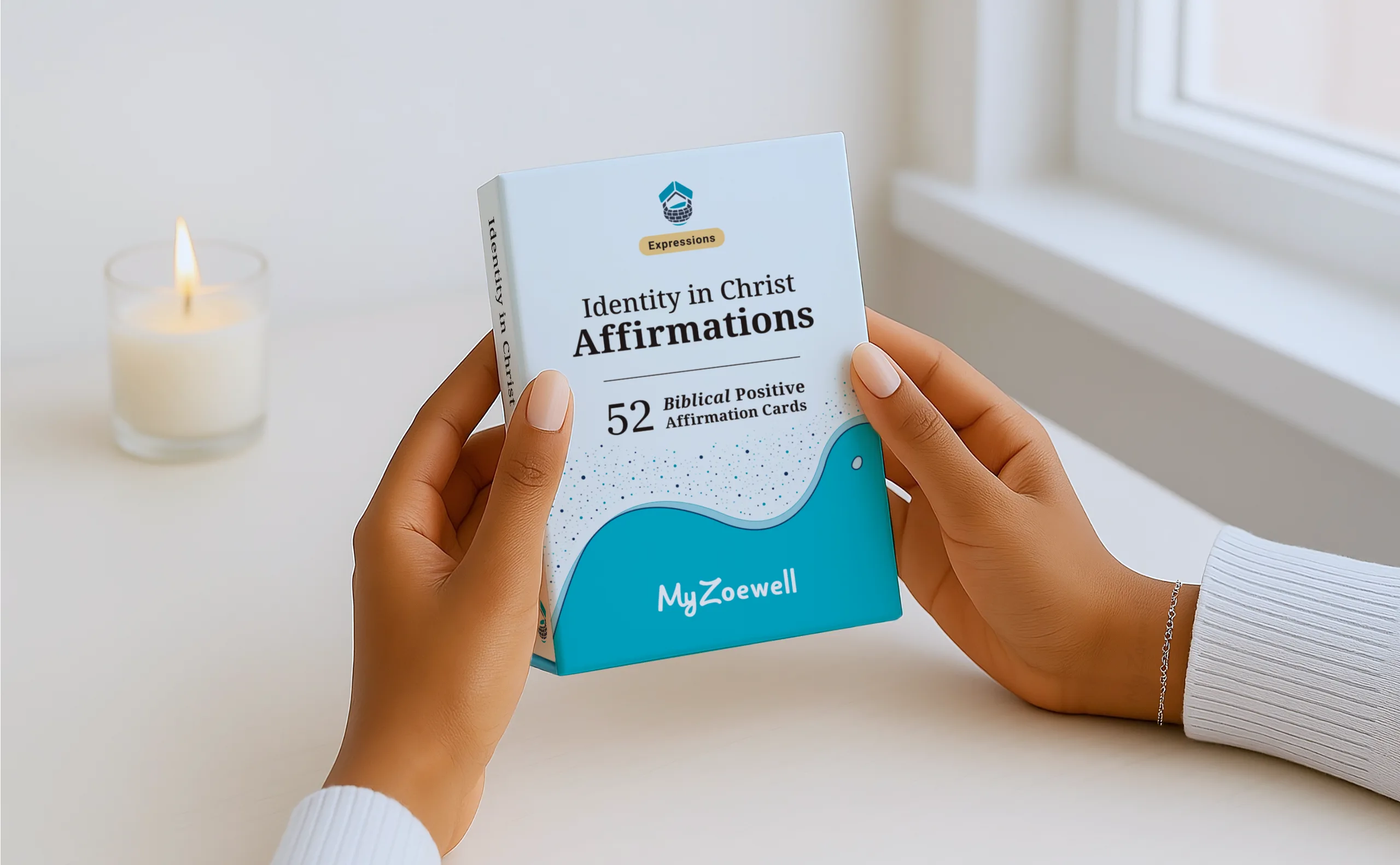 Identity in Christ Affirmations card deck box being held by manicured hands near window